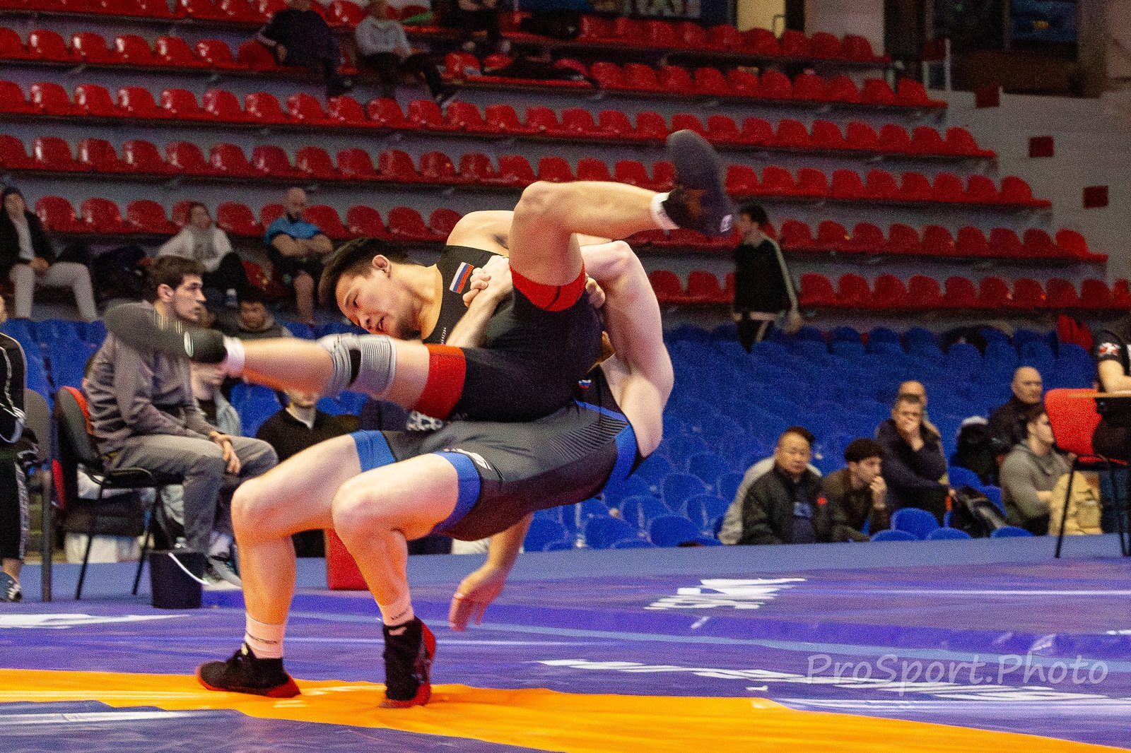 Бросок из стойки; один борец поднимает соперника над ковром. Чемпионат России среди студентов по вольной борьбе — 2026.